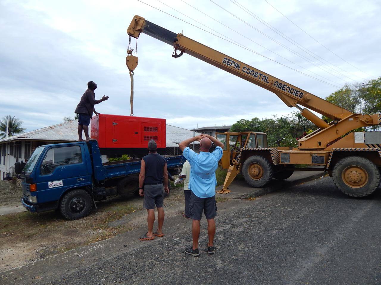 An image of FIA team moving equipment with a crane.