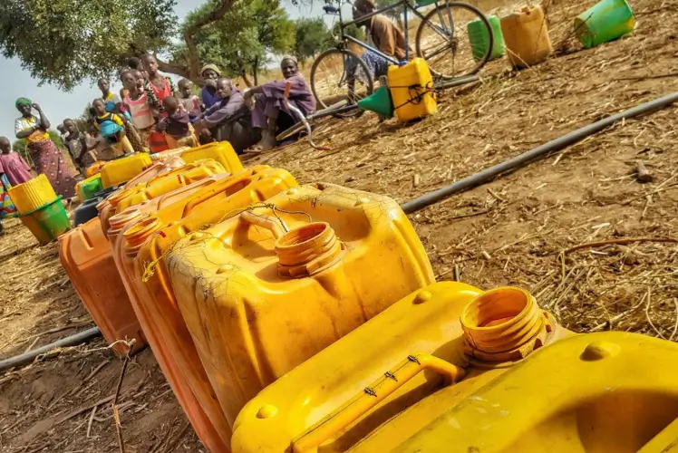 Banner image of water containers illustrating Friends In Actions, clean water initiative projects.