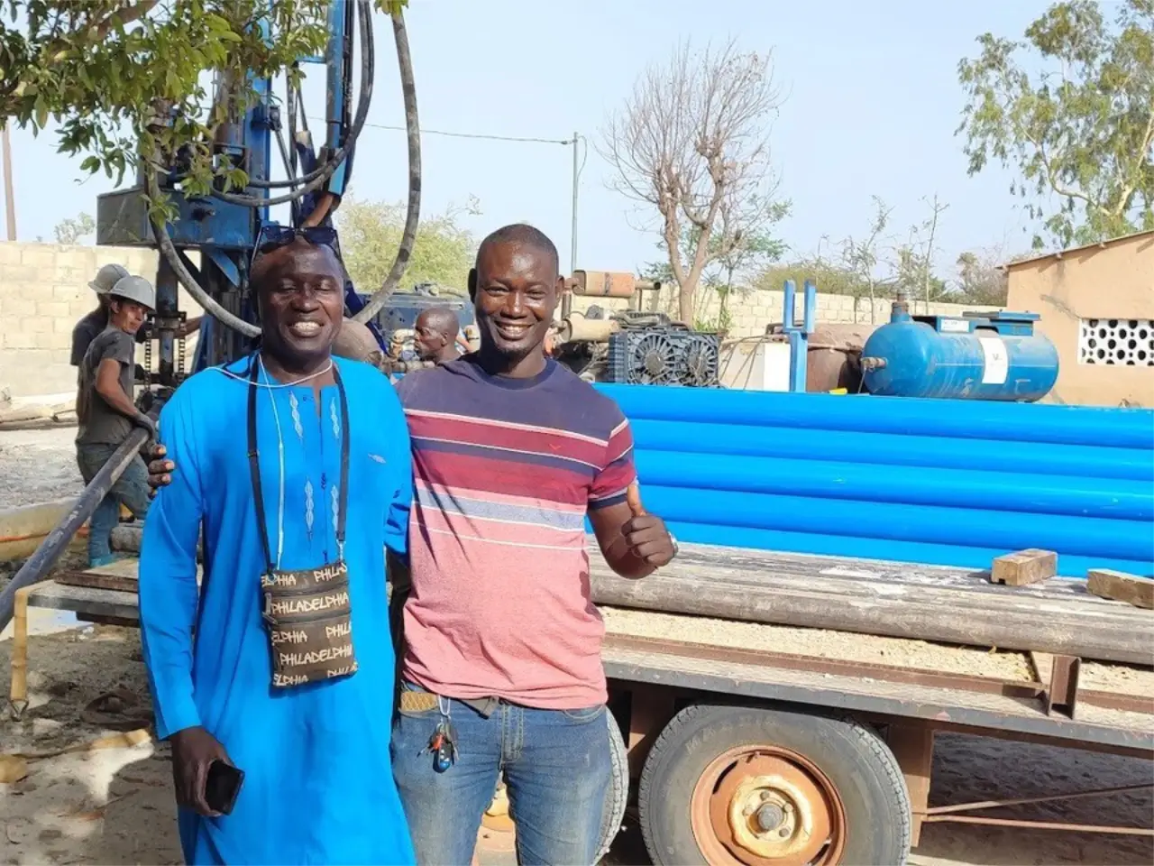 Pastor Ernest and friend with Friends In Action International team