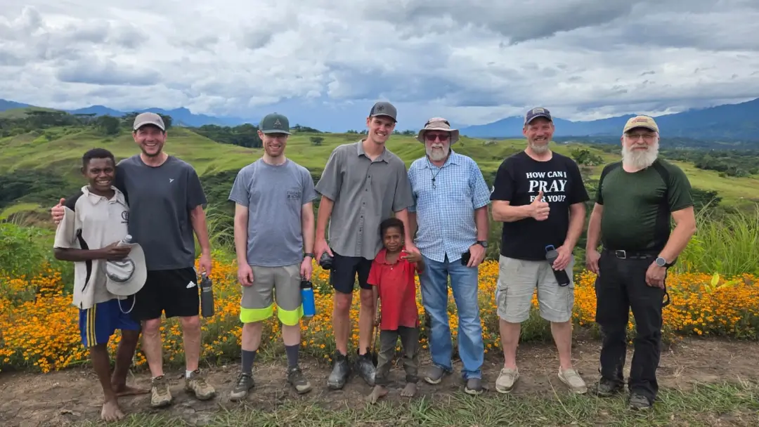 Echoes of His Grace - FIA volunteers and two local children