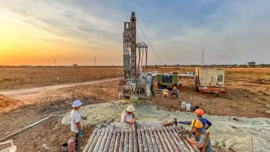 trip-africa-slider Men with Friends In Action Intl. watch as drilling rig digs hole for well in Senegal West Africa.