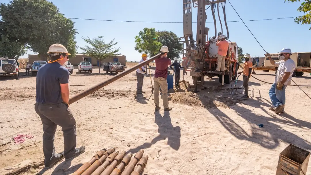 FIA volunteers assisting in drilling a well in West Africa.