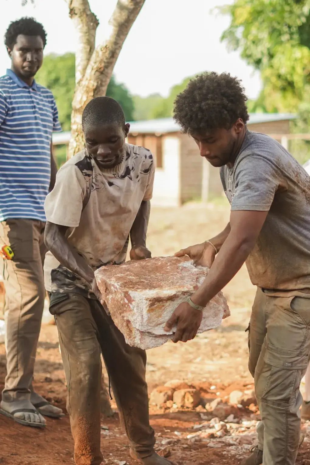 Banner image of a Andy Bachert , COO of Friends In Action Intl., welding on a multi-trade construction project.