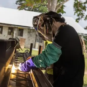 Friends In Action International volunteer welding in Vanuatu.