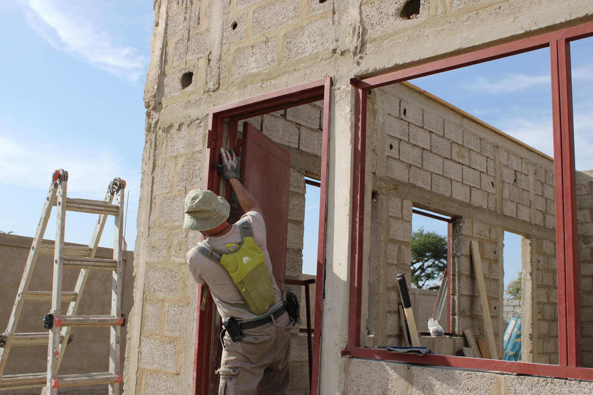 One of the team members installing a door frame for the intern house.
